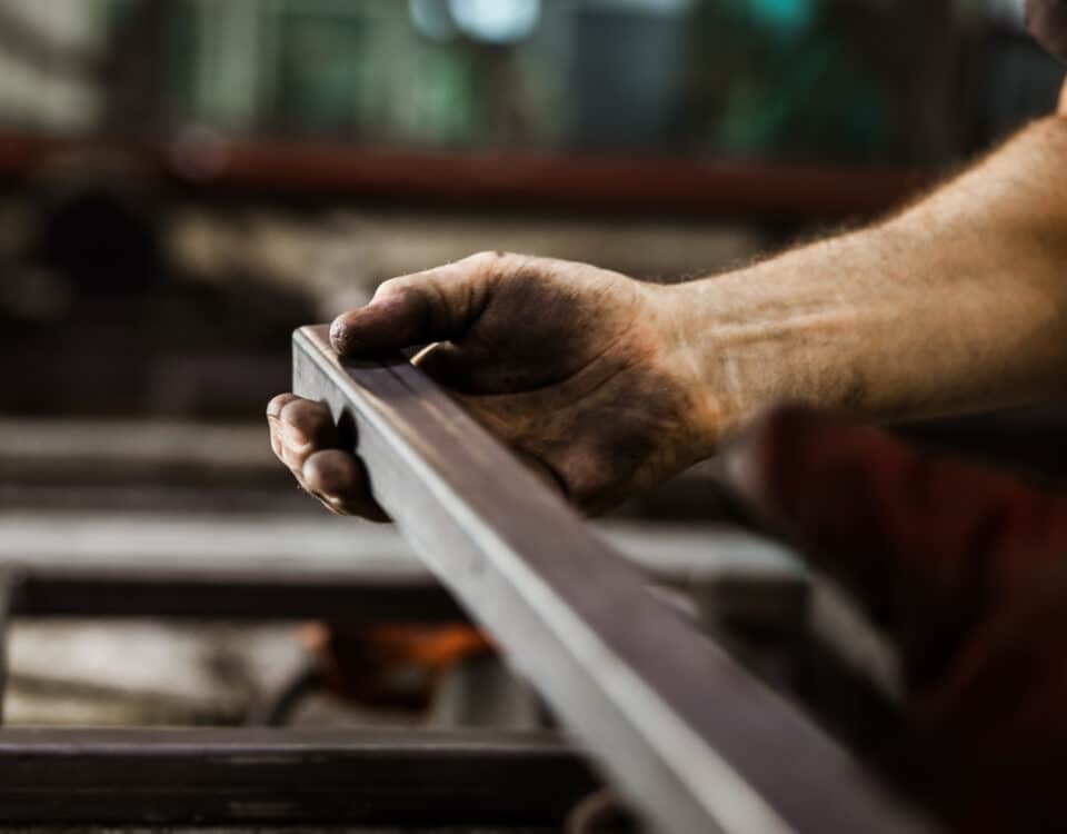 Close up of unrecognizable worker working with iron.