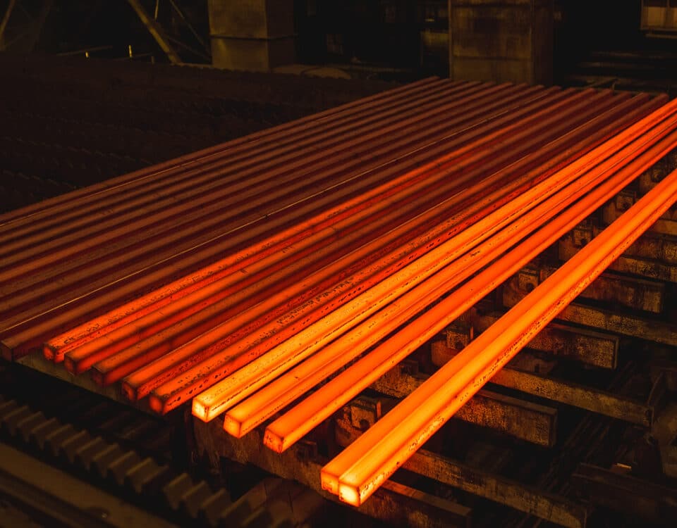 Hot square steel bloom on the roll table.