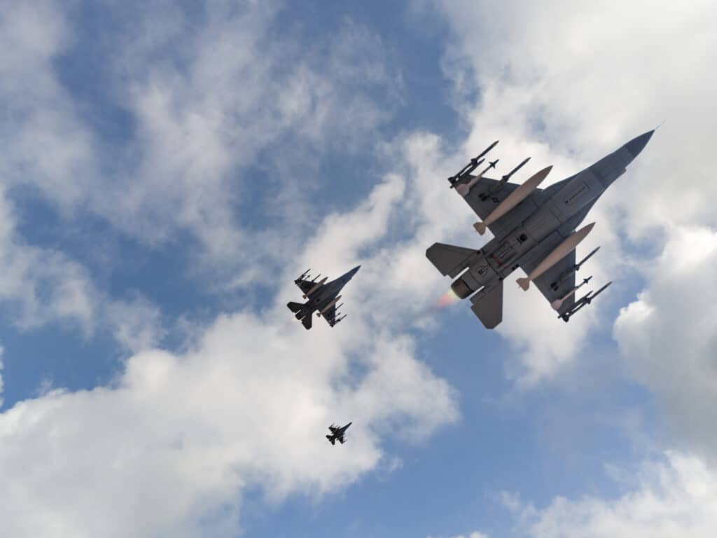 Bottom view of Jet aircrafts flying over the clouds.